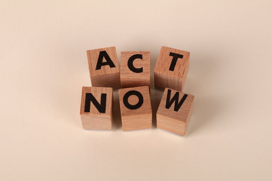 Wooden blocks with letters spelling 'ACT NOW', promoting urgency and motivation.